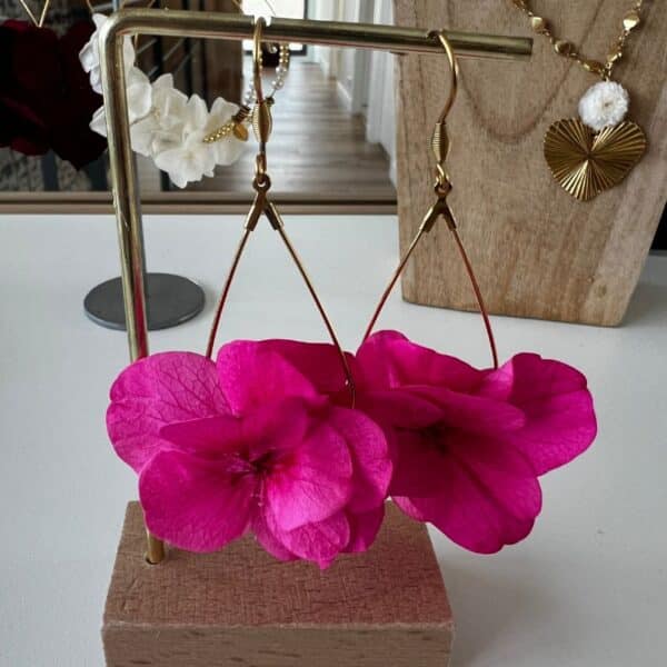 Audacieuses et vibrantes, les boucles d’oreilles Côme révèlent toute la beauté de l’hortensia fuchsia. Une création florale intense et lumineuse, pensée pour celles qui aiment affirmer leur style avec élégance.