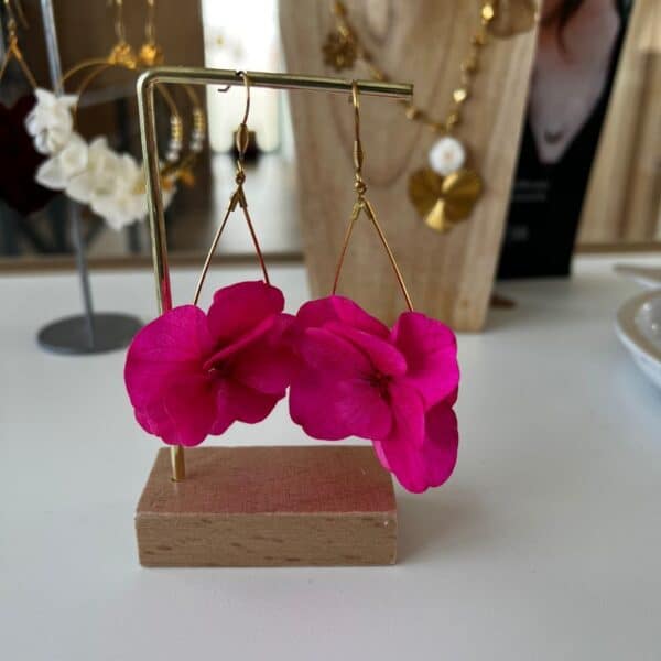 Audacieuses et vibrantes, les boucles d’oreilles Côme révèlent toute la beauté de l’hortensia fuchsia. Une création florale intense et lumineuse, pensée pour celles qui aiment affirmer leur style avec élégance.